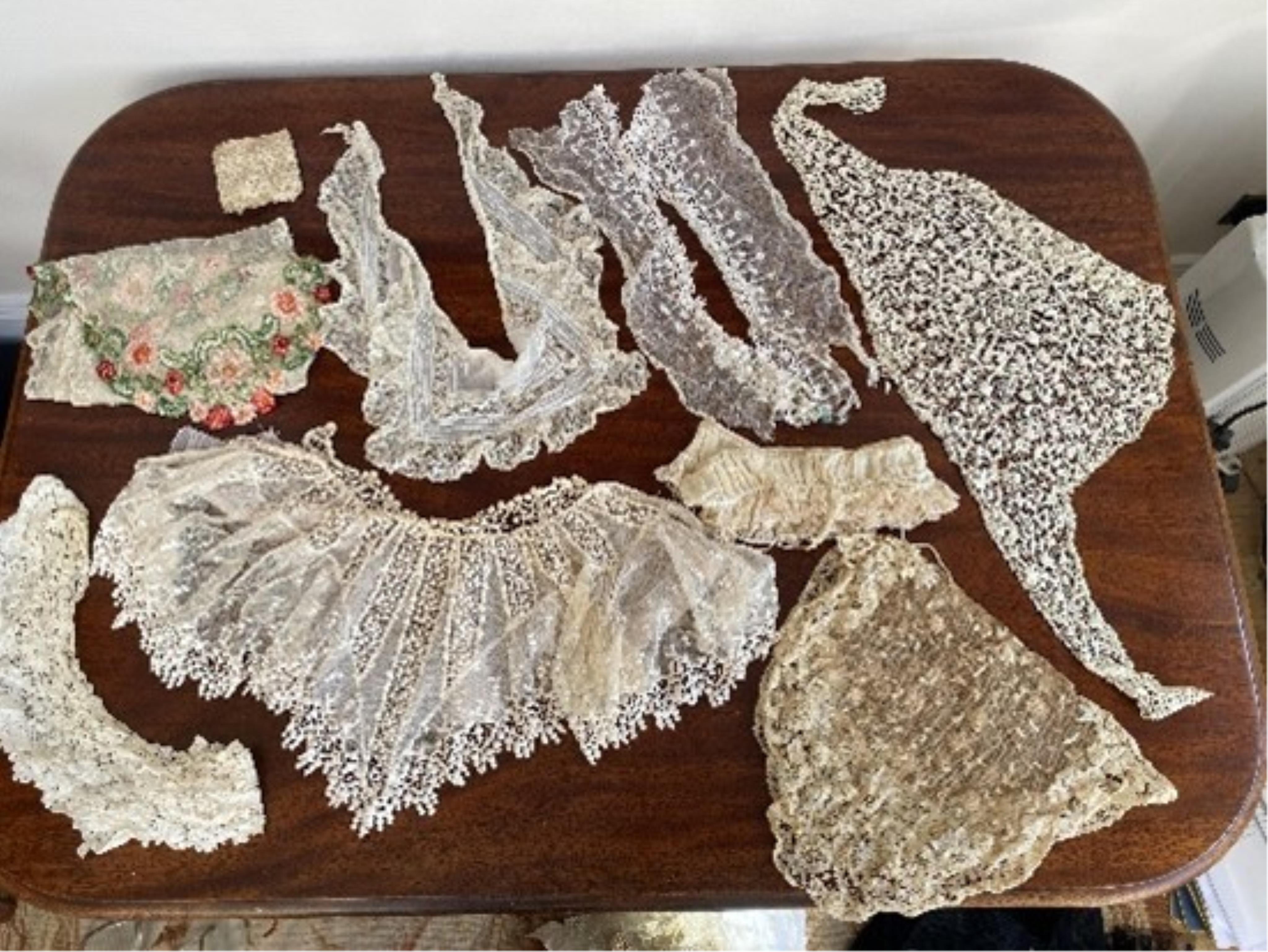 An assortment of black and cream lace pieces, antique, vintage and modern